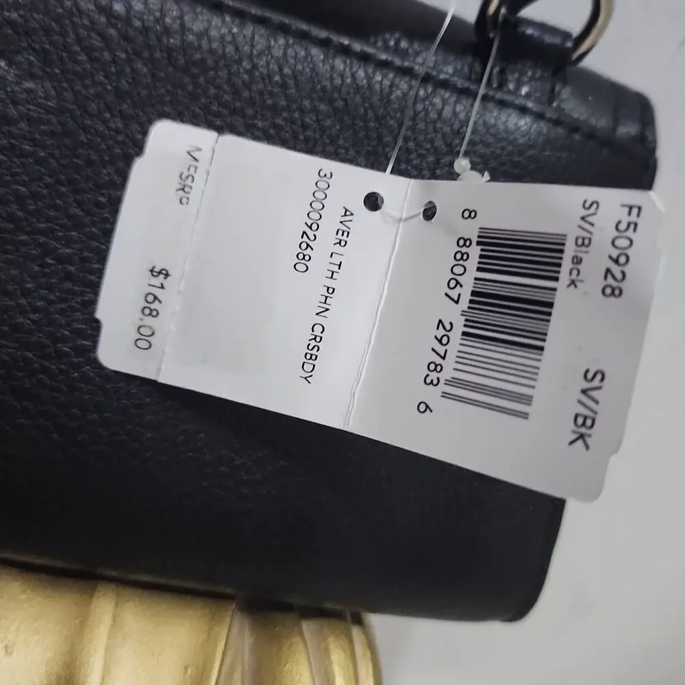 Coach Avery leather phone crossbody w/ a flap closure.